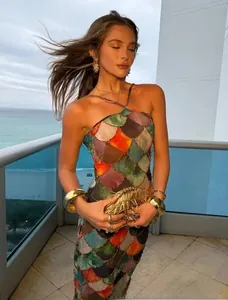 Detail of halter neck maxi dress with colorful fish scale print for beach parties
