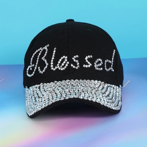 Detail of Blessed rhinestone lettering and crystal embellishments on black denim baseball cap