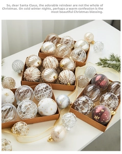 Detail of assorted Christmas balls in craft boxes with gold ribbons and pine branches