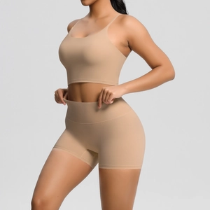 Detailed front view of seamless high-waist yoga shorts and strappy sports bra set