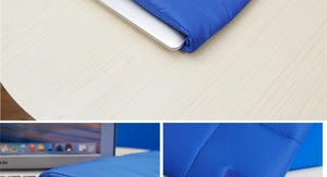 Close-up of blue quilted laptop sleeve with soft padded fabric and horizontal stitching