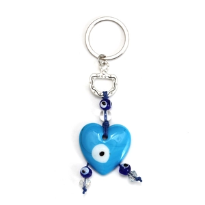 Macro detail of sky blue heart evil eye keychain with blue beads and silver ring
