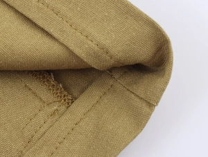 Detailed macro view of khaki linen-blend blazer showing high-quality double-stitched seams