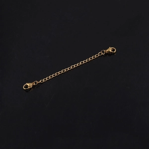 Macro detail of golden stainless steel extender chain with dual lobster clasps