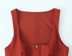 Detail view of brick red square neck top with textured fabric and dark resin button
