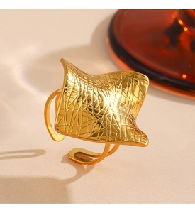 Macro shot of 18K gold plated titanium steel ring with 3D wave texture and open band