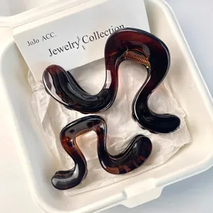 Set of tortoise shell hair claws in wavy organic shape for high ponytail styling
