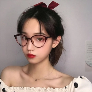 Chic cat-eye blue light blocking glasses in dark red tortoise finish on female model