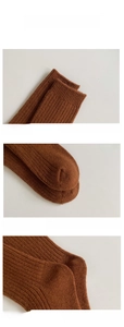 Detail view showing elastic ribbed cuff, dense knit texture, and reinforced toe of wool socks
