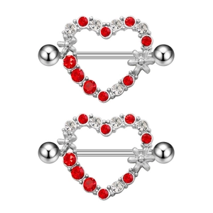 Detailed macro view of heart-shaped nipple rings with red and white zircon crystals