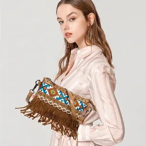 Bohemian tassel crossbody bag with ethnic patterns and silver buckles shown on a model