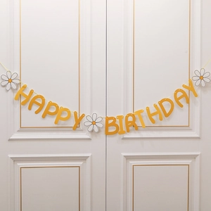 Daisy macaron birthday banner with yellow letters and white flowers for party decor