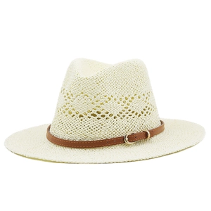 Close-up of cream handmade woven straw fedora hat with brown leather band and gold buckle