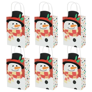 Close-up of Christmas kraft paper gift bags featuring cartoon snowman and rope handles