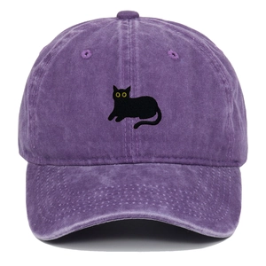 Close-up of black cat embroidery on a vintage washed purple cotton baseball cap