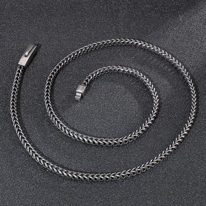 Macro view of vintage silver wheat chain necklace with detailed metal texture and clasp