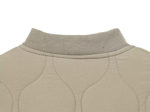 Detailed close-up of khaki stand-up collar with ribbed knit and quilted fabric texture