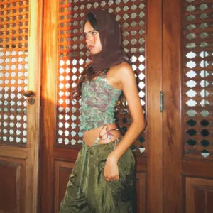 Detail of floral halter tube top featuring colorful beaded ties and adjustable side lacing