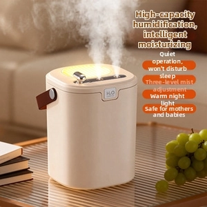 Detail of portable humidifier with leather handle and dual spray mist nozzles on glass table