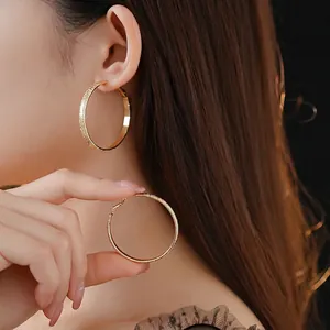 Chic gold hoop earrings with textured finish and smooth surface for elegant look