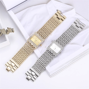 Detailed view of silver and gold square quartz watches with crystal-set bracelets