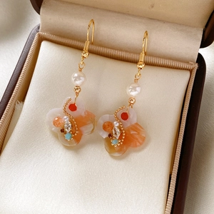 Detail of vintage palace style flower earrings with pearls and colorful stones