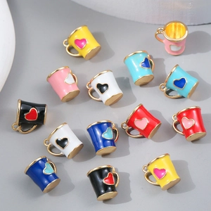 Enamel tea cup pendants with heart patterns and gold trim for DIY jewelry making
