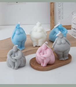 Artistic human body torso candles in various colors for creative home decor