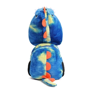 Detail of blue and yellow tie-dye dinosaur plush backpack with orange felt spines and tail