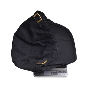 Detailed view of the 88g lightweight cotton beret on a digital scale for weight verification