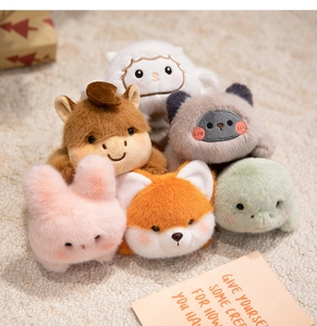 Close-up of assorted plush animal magnets with embroidery details on soft fleece background