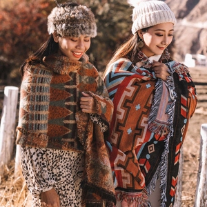 Outdoor shot showing thick bohemian camping blankets with fringe and ethnic patterns