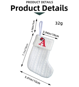 Detailed cable-knit white Christmas stocking with embroidered red letter A and hanging loop