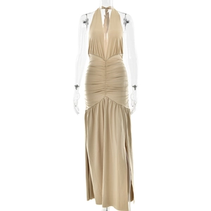 Detailed view of backless halter dress with side split and pleated waist detail in beige