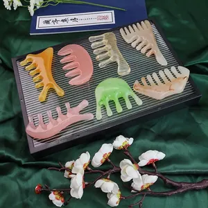 Multi-color scalp massage comb set with wide teeth on elegant silk background