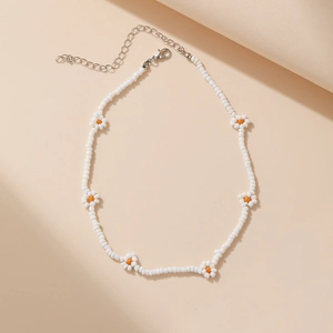 Close-up of handmade white seed bead daisy necklace with silver lobster clasp and chain