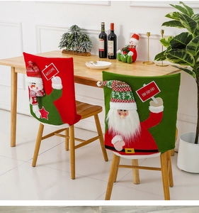 Detailed view of red snowman and green Santa knitted chair covers in a festive dining set