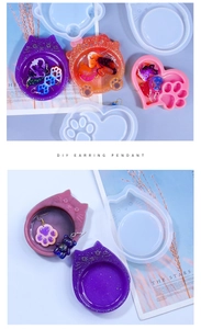 DIY silicone mold featuring cat head and heart paw designs with glitter resin pendants