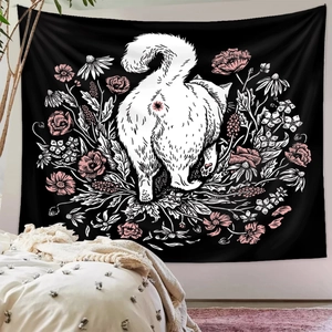 Detailed close-up of bohemian black tapestry with white cat and pink floral design on a wall