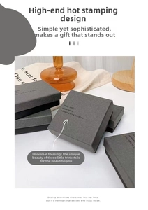 Minimalist grey matte jewelry gift box with gold foil printing and cardboard texture