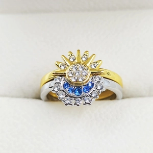 Detail of celestial sun and moon nesting rings with sparkling blue and white gemstones