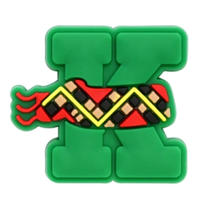Detailed view of PVC letter K charm with green base and colorful wave patterns for clogs