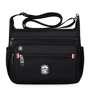 Multi-compartment black nylon messenger bag with adjustable strap for business commute