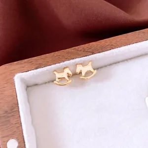 18K gold plated rocking horse earrings displayed on a luxury wooden jewelry tray