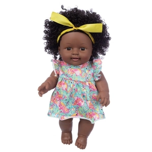 Detail of 12-inch African American girl doll with curly hair and pink flamingo dress