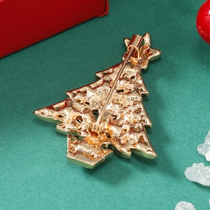 Detailed back view of a golden Christmas tree brooch with a secure safety pin closure