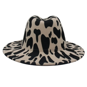 Classic wide brim fedora hat with black and white cow print patterns in wool felt