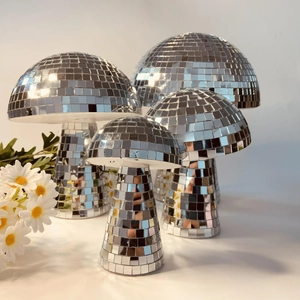 Set of four mirrored mushroom disco balls with silver tiles on a clean white background