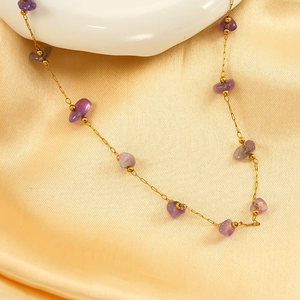 Elegant purple amethyst gravel necklace with gold beads on a champagne silk background