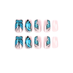 Press-on nails featuring nude pink base and blue glitter butterfly designs on white background